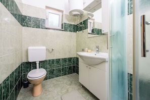 A bathroom with a toilet, sink, and shower. - Apartment David (Liznjan)