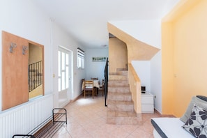A modern interior with a staircase, a dining area, and a bed. - Apartments Miranda (Lopar)