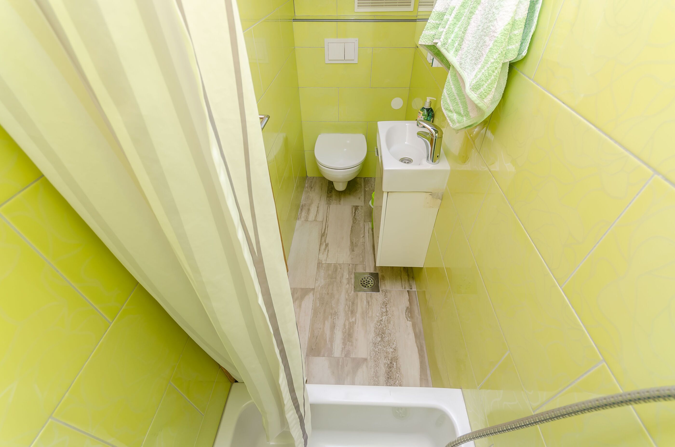 A small bathroom with a toilet, sink, and bathtub.