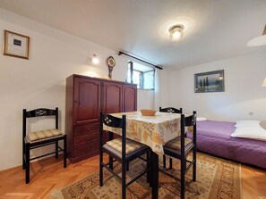 A dining area with a table, chairs, and a cabinet. - Apartments Vida (Novi Vinodolski)