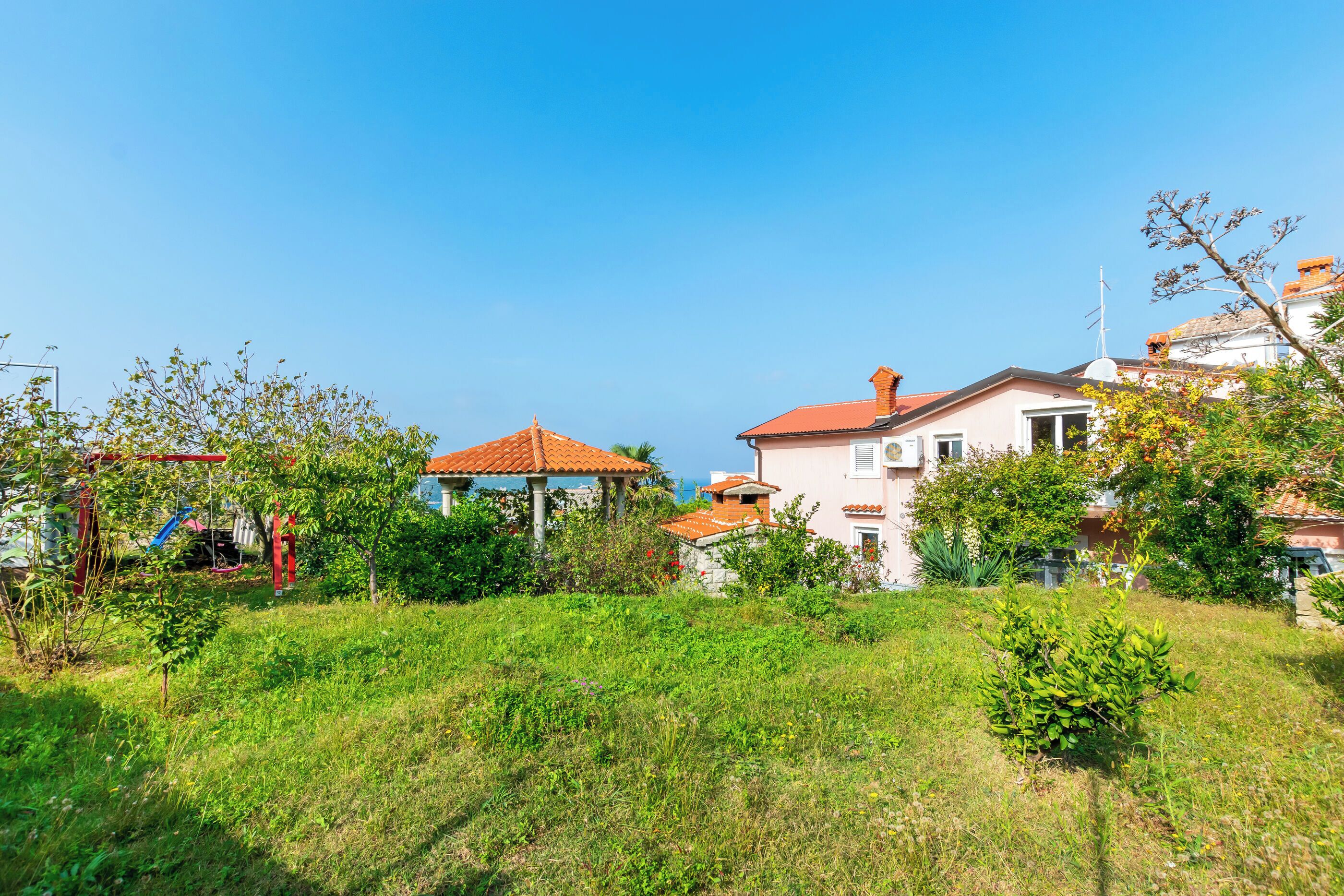 A residential area with houses, a gazebo, and a playground.