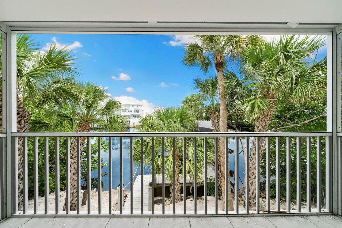 Serene water view framed by tropical trees right outside your door