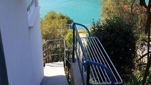 Een trap die leidt naar een balkon met uitzicht op een wateroppervlak.