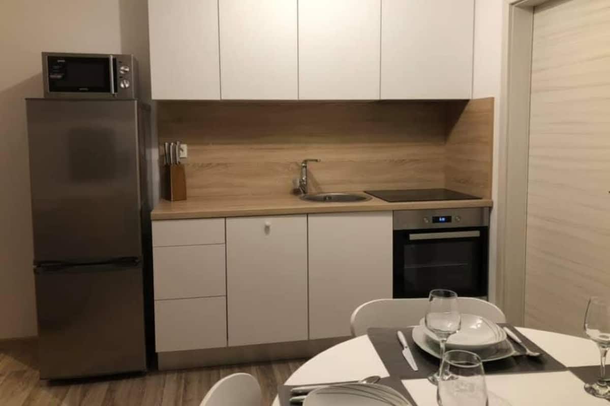 Eine moderne Küche mit Kühlschrank, Mikrowelle, Spüle und Geschirrspüler.