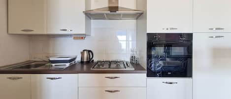Apartment (A1) | Private kitchen | Fridge, microwave, oven, stovetop