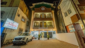 A two-story building with a sign reading "The Sangan" and a parked SUV in front. - The Sangam Hotel Mahabaleshwar (Mahabaleshwar)