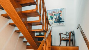 A wooden staircase with a chair at the bottom. - Apartment Peaceful Paradise (Bakar)