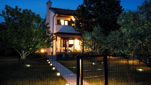 A two-story house with a stone facade, a tiled roof, and a visible chimney. - Apartment Peaceful Paradise (Bakar)