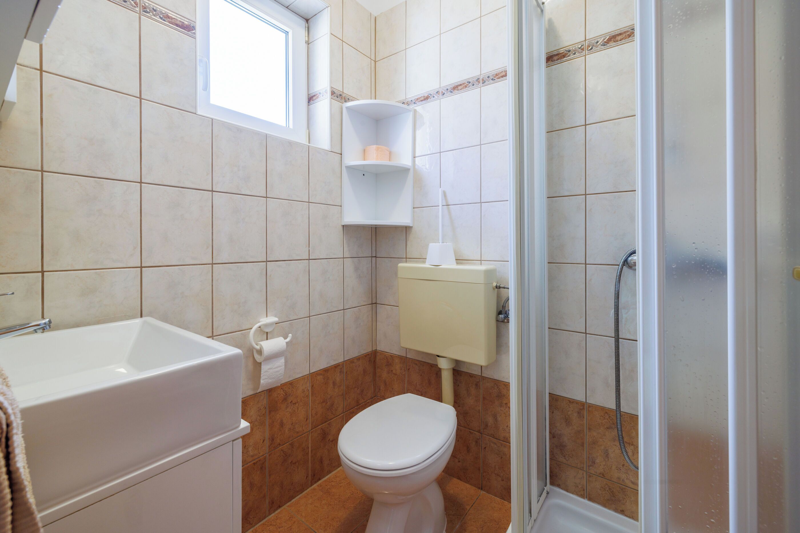 A bathroom with a bathtub, toilet, and shower.