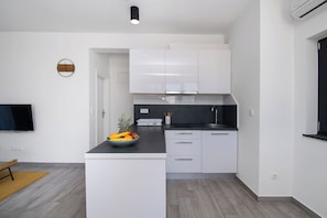 Apartment (A2) | Private kitchen | Fridge, stovetop, cookware/dishes/utensils - Apartments Slavica (Vodice)