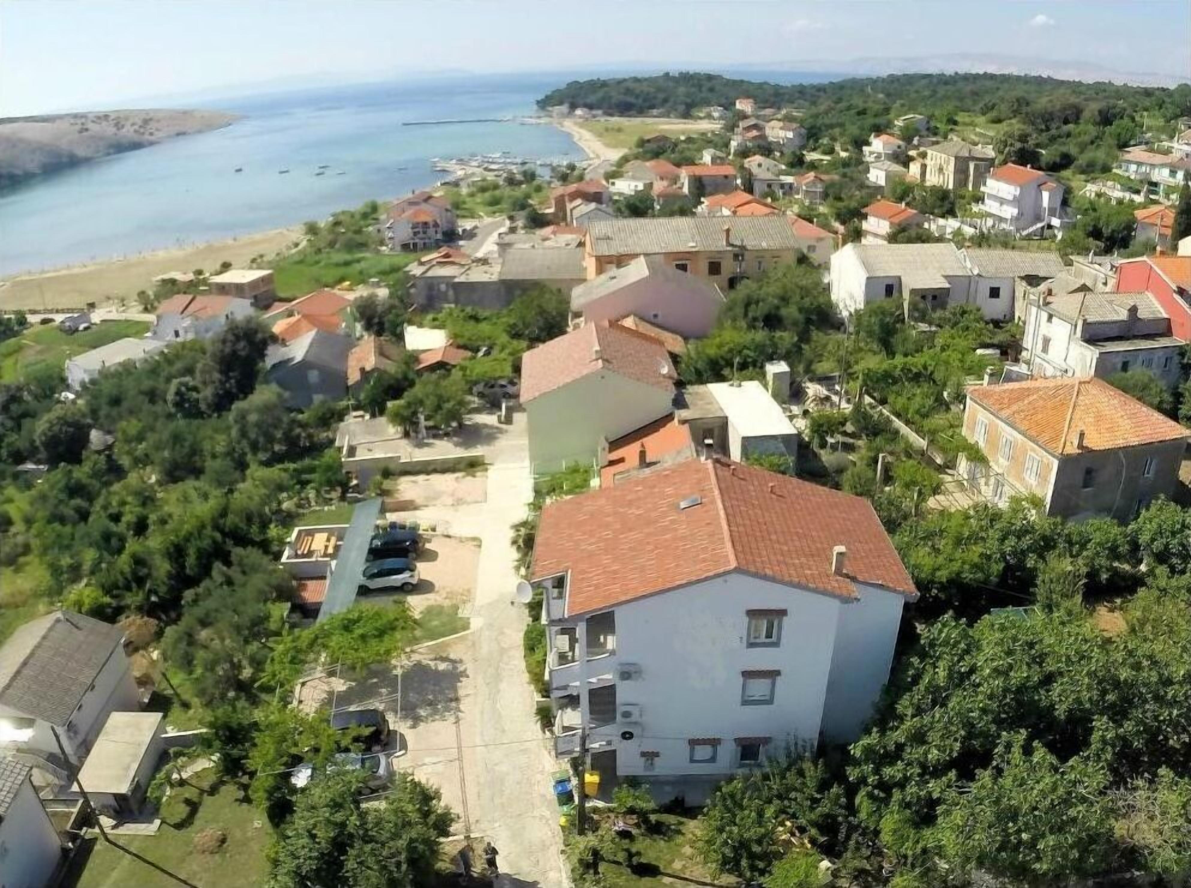 A coastal residential area with houses, a beach, and boats.