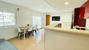 Un apartamento moderno con cocina, comedor y balcón.