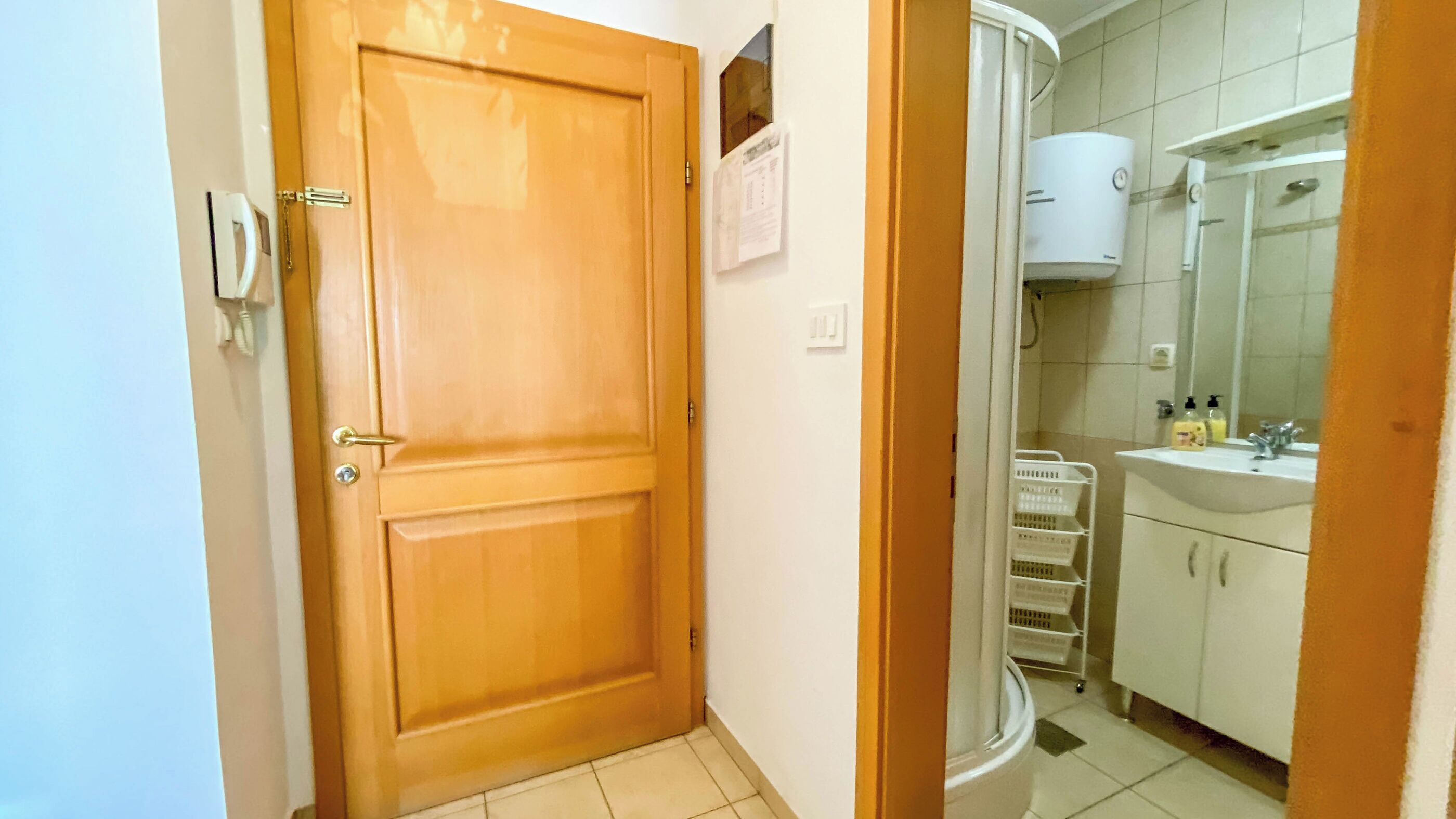 A bathroom with a shower, sink, and toilet.
