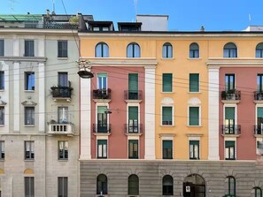 A row of multi-story buildings with balconies and arched windows. - Botanical Modernist House | Milanese Lifestyle (Milano)