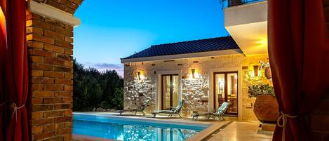 Outdoor pool, a heated pool, pool umbrellas, pool loungers