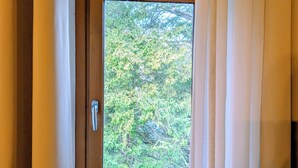 A window with a view of trees outside. - Maison Cévenole - Village center - Flexible arrival (Saint-Jean-du-Gard)