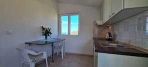 Apartment (A1) | Private kitchen | Fridge, stovetop, electric kettle, cookware/dishes/utensils