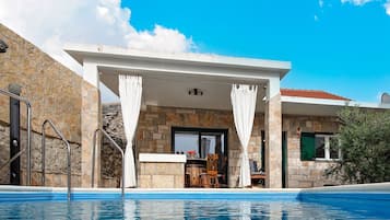 Outdoor pool, a heated pool, open open 24 hours, pool umbrellas