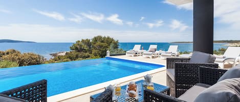 Outdoor pool, an infinity pool, sun loungers