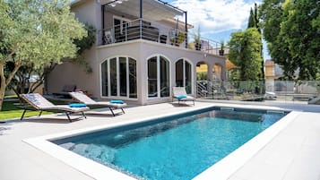 Una piscina al aire libre, una piscina climatizada