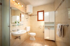 A modern bathroom with a sink, toilet, and cabinet. - House Peacefull Relax (Jelsa)