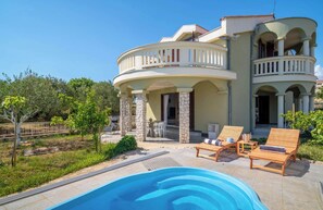 A two-story house with a pool, outdoor furniture, and a garden. - Villa Rita (Sveti Filip i Jakov)