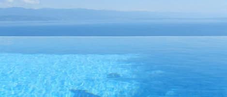 Outdoor pool, an infinity pool, pool loungers