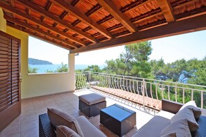 A balcony with a wooden ceiling, outdoor furniture, and a view of the sea. - Villa Korcula (Blato)