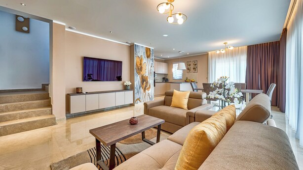 A modern living room with a sofa, coffee table, and a painting on the wall. - Villa Astrid (Rasa)