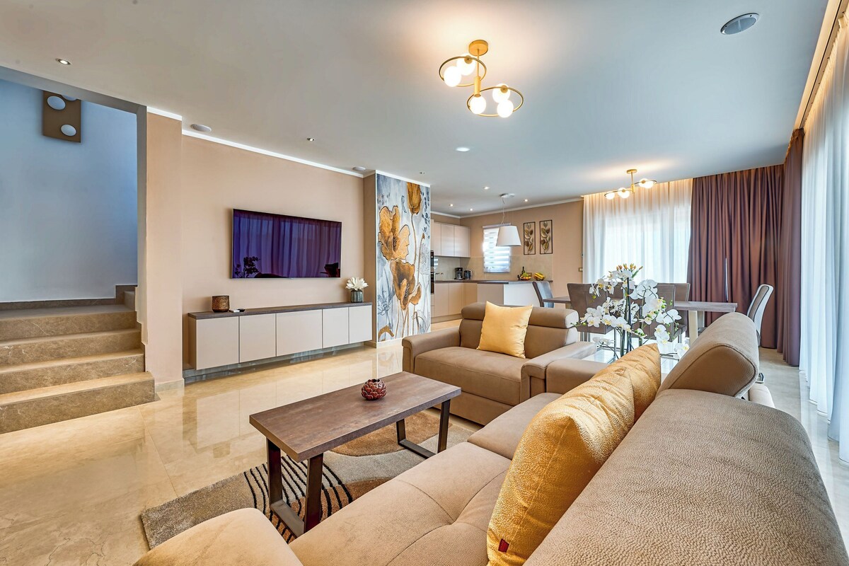 A modern living room with a sofa, coffee table, and a painting on the wall.