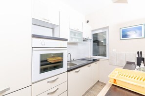 Apartamento (A4) | Cozinha privada | Geladeira, fogão, cooktop, lava-louças