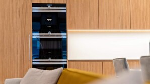 A modern kitchen with built-in appliances, a wooden cabinet, and a whiteboard. - Villa Aprilia (Zadar)