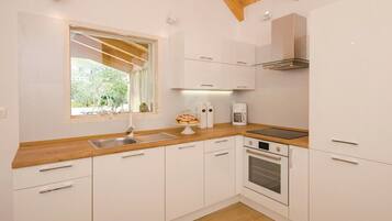 Villa | Private kitchen | Fridge, microwave, oven, stovetop