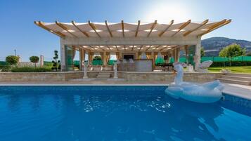 Outdoor pool, a heated pool, pool umbrellas
