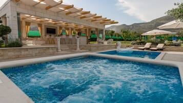 Outdoor pool, a heated pool, pool umbrellas