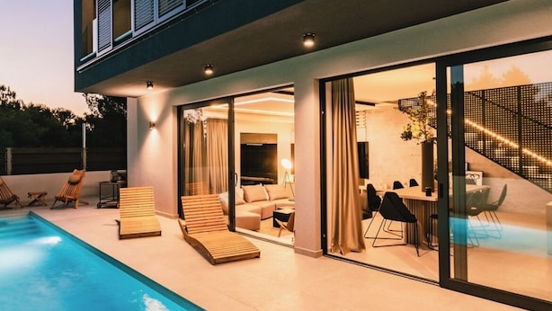 A modern two-story house with a swimming pool, outdoor seating, and a dining area. - Villa Chic (Vodice)
