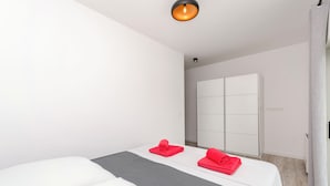 Ett hotellrum med två sängar, en garderob och ett badrum.