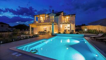 Outdoor pool, a heated pool, open open 24 hours, pool umbrellas