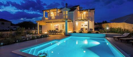 Outdoor pool, a heated pool, open open 24 hours, pool umbrellas