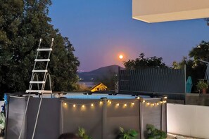 A rooftop terrace with a ladder, string lights, and potted plants. - Villa Raslina Sea View (Sibenik)