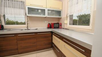 Villa | Private kitchen | Fridge, microwave, oven, stovetop