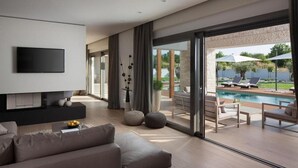 A modern living room with a flat-screen TV, a sofa, and a large sliding glass door leading to an outdoor pool area. - Villa Royal Green (Rasa)