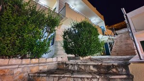 A multi-level building with stone steps leading up to a staircase. - Villa Casa With Indoor Pool (Dugi Rat)
