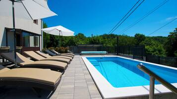Outdoor pool, a heated pool, open open 24 hours, pool umbrellas
