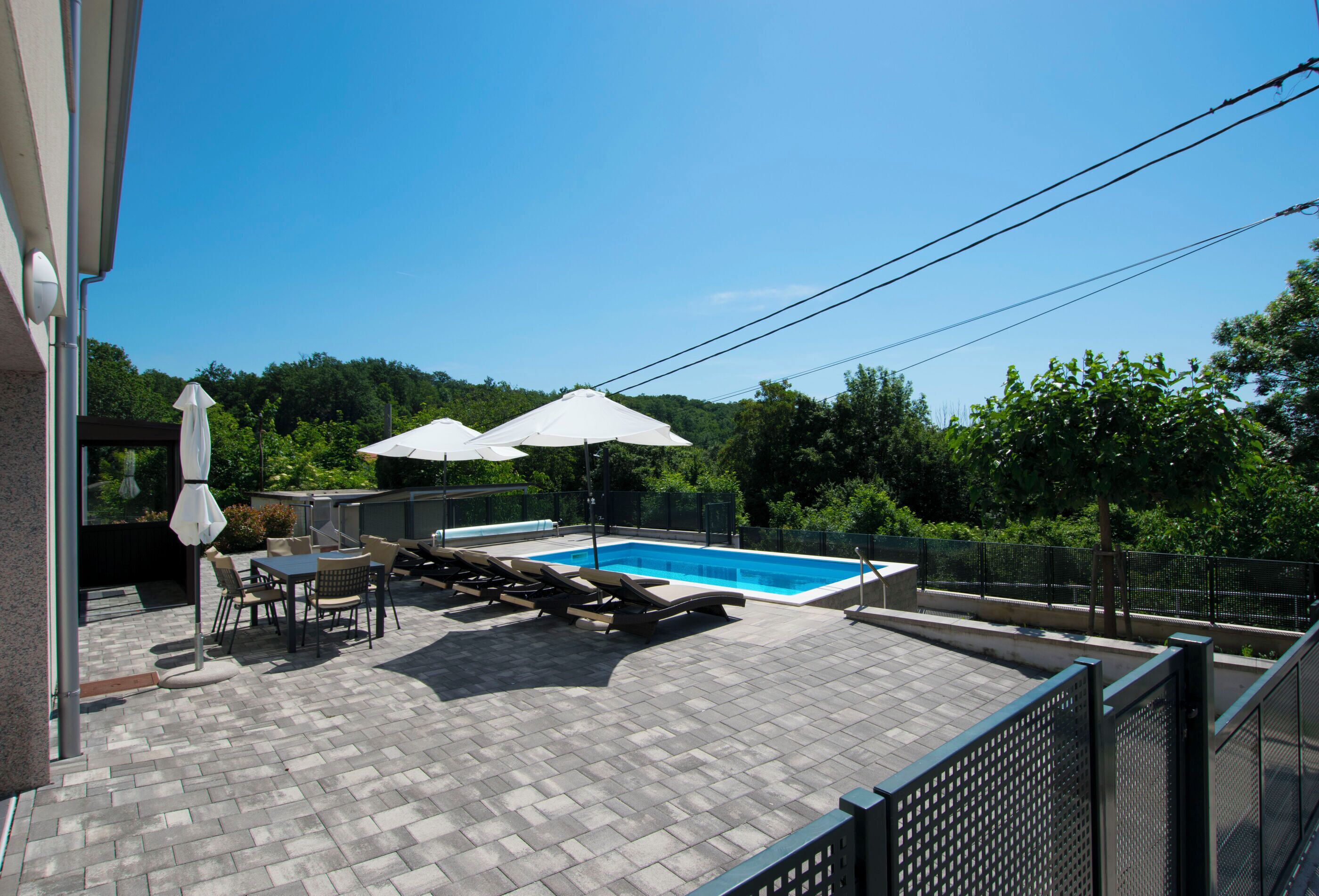 Outdoor pool, a heated pool, open open 24 hours, pool umbrellas