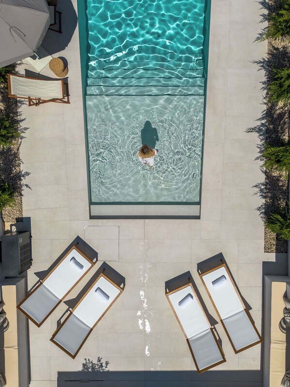 Outdoor pool, a heated pool, open open 24 hours, pool umbrellas