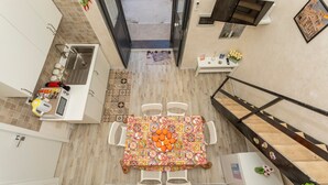 A top-down view of a kitchen with a dining area, a sink, and a refrigerator. - Apartment 'Catania Del Mio Cuore' – Central, Sleeps 6, Family-Friendly (Catania)