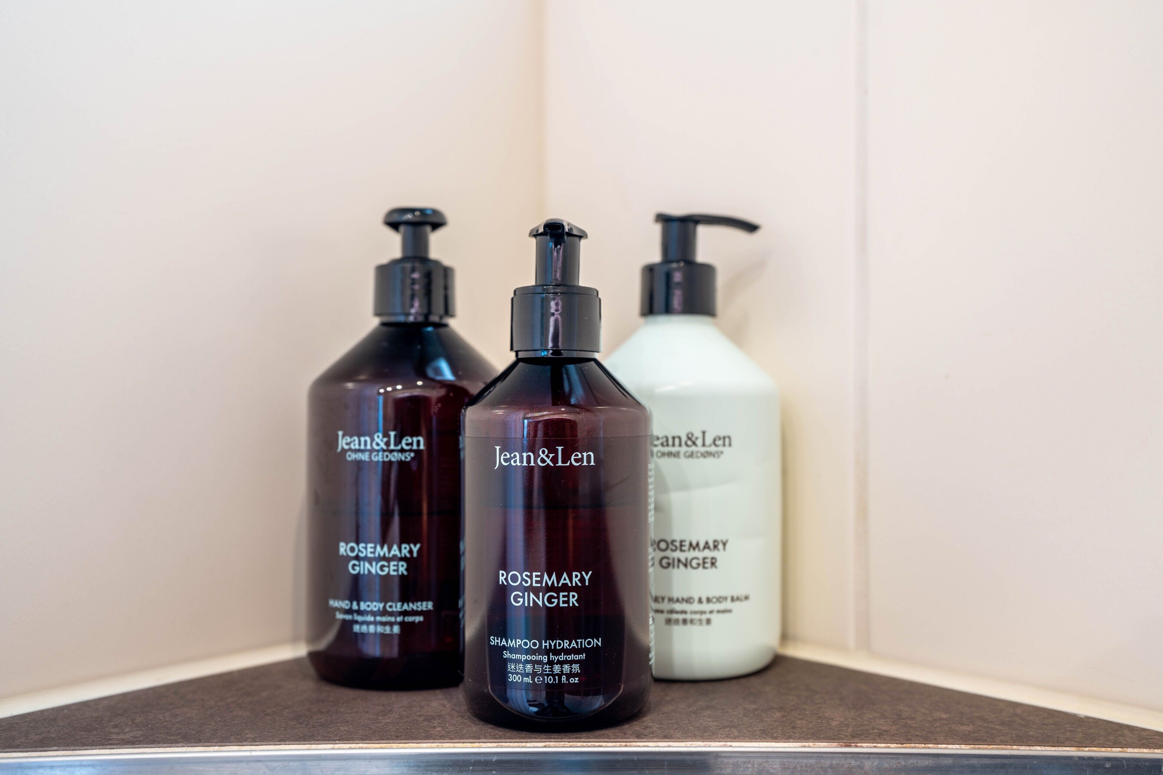 Three bottles of Jean & Len products on a shelf.