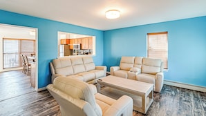 A living room with beige sofas and a coffee table, a dining area with wooden chairs, and a kitchen in the background. - Hot Tub & Sauna! Atlantic City Getaway By Beach (Atlantic City)