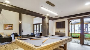 A pool table with cues, a sofa, and a view of a children's play area through glass doors. - Walk to Gondola! Keystone Gem in River Run Village (Keystone)